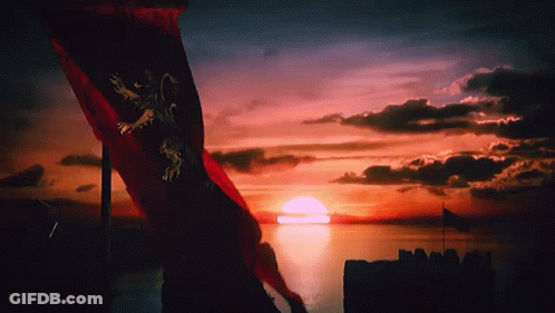 A Red Flag With A Lion On It Is Flying In Front Of A Sunset Over A Body Of Water GIF