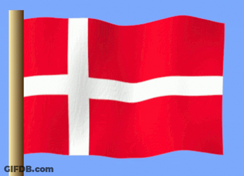 A Red Flag With A White Cross On It Is Waving In The Wind GIF