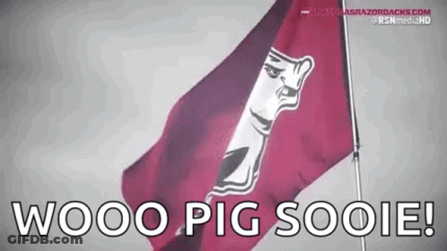 A Red Flag With A White Face On It Is Flying In The Wind . GIF