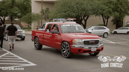 A Red Gmc Truck With The Number 20 On The Side GIF