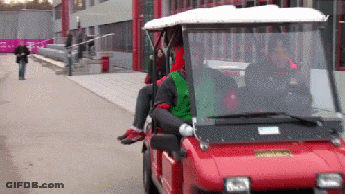 A Red Golf Cart With The Word T Mobile On The Side GIF