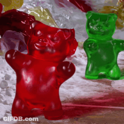 A Red Gummy Bear And A Green Gummy Bear GIF