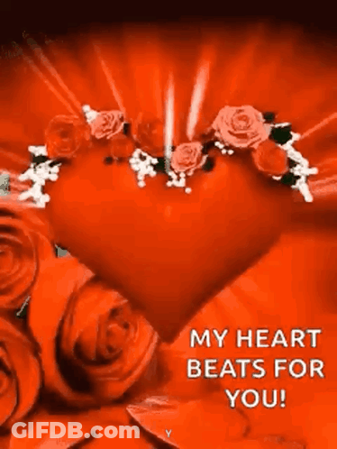 A Red Heart Surrounded By Red Roses With A Message That Says `` My Heart Beats For You '' . GIF