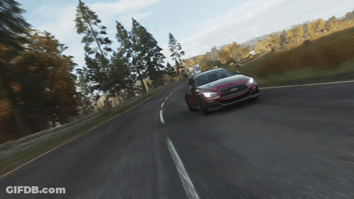 A Red Infiniti Car Is Driving Down A Road With Trees In The Background GIF