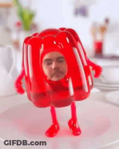 A Red Jelly Figurine With A Man 'S Face On It GIF