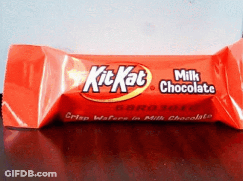 A Red Kitkat Milk Chocolate Bar Sitting On A Table GIF