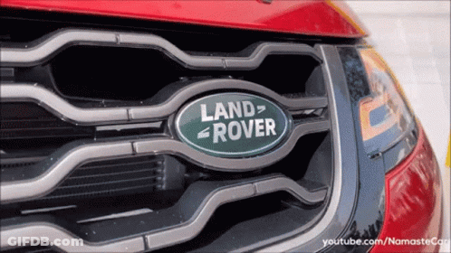 A Red Land Rover Is Parked In A Driveway GIF