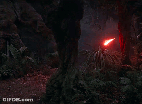A Red Light Beam Is Coming Out Of A Red Object In The Dark . GIF