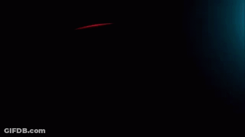 A Red Light Is Coming Out Of A Dark Background GIF