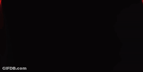 A Red Light Is Shining On A Dark Background GIF