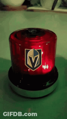 A Red Light With A Golden Knights Logo On It Sits On A Table GIF