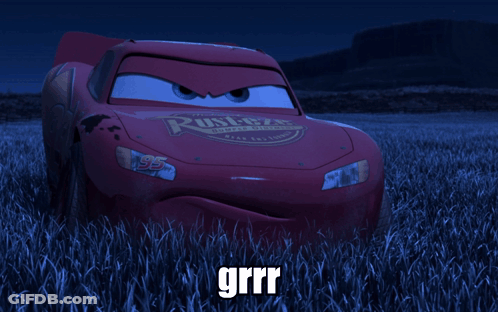 A Red Lightning Mcqueen Car Is Sitting In A Field Of Tall Grass GIF