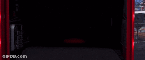 A Red Lightning Mcqueen From Cars Is Smiling In A Garage GIF