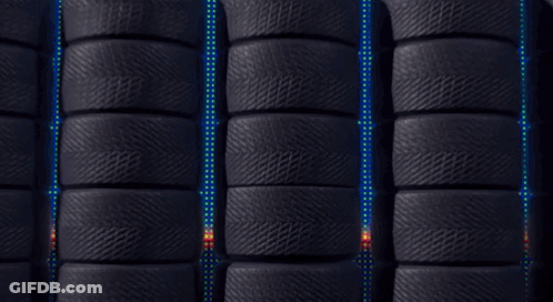 A Red Lightyear 95 Car Is Surrounded By Black Tires GIF