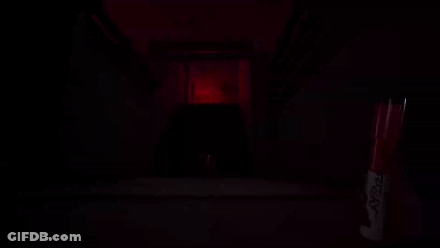 A Red Marker With The Word Sharpie On It Sits In A Dark Room GIF