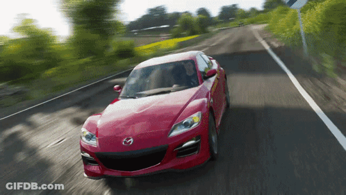 A Red Mazda Car Is Driving Down A Country Road GIF