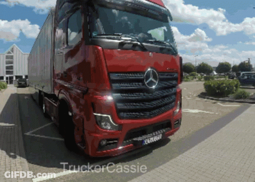 A Red Mercedes Truck Is Parked In A Parking Lot By Trucker Cassie GIF