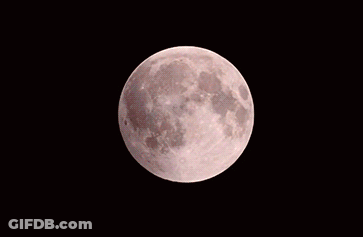 A Red Moon In The Night Sky With A White Crescent GIF