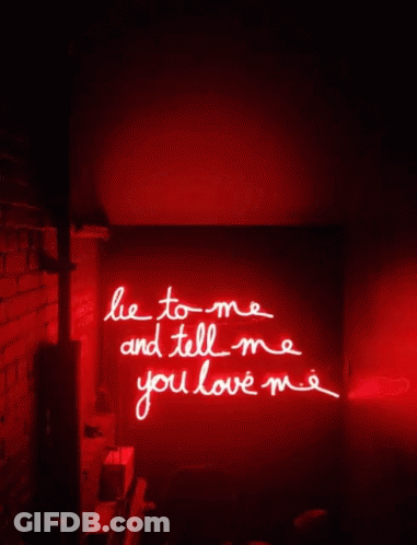 A Red Neon Sign Says Lie To Me And Tell Me You Love Me GIF