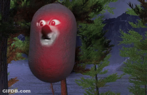 A Red Object With A Face On It Is Standing In A Forest GIF