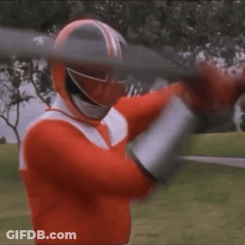 A Red Power Ranger Is Holding A Large Sword In His Hands . GIF
