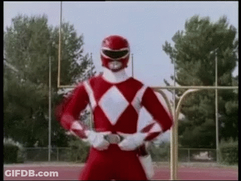 A Red Power Ranger Is Standing On A Track With His Arms Crossed . GIF