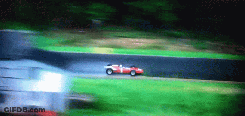A Red Race Car With The Number 1 On The Side Is Driving Down A Track GIF