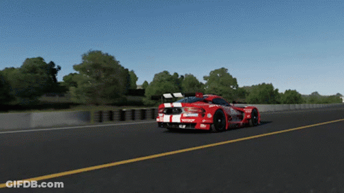 A Red Race Car With The Word Castrol On The Side Is Driving Down A Road GIF