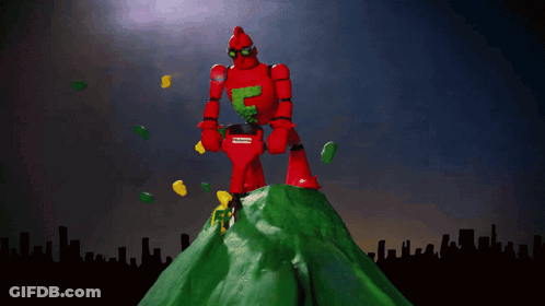 A Red Robot Is Standing On Top Of A Green Hill With The Words Frederator Studios Above Him GIF