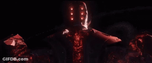 A Red Robot With A Glowing Head Is Standing In The Dark GIF