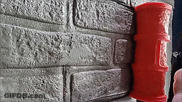 A Red Roller Is Sitting On A Brick Wall Next To A Brick Wall . GIF