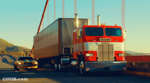 A Red Semi Truck With The Word Freightliner On The Side GIF