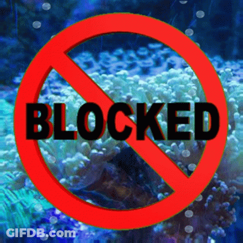 A Red Sign That Says Blocked In Black Letters GIF