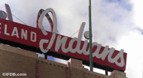 A Red Sign That Says Cleveland Indians On Top Of A Building GIF