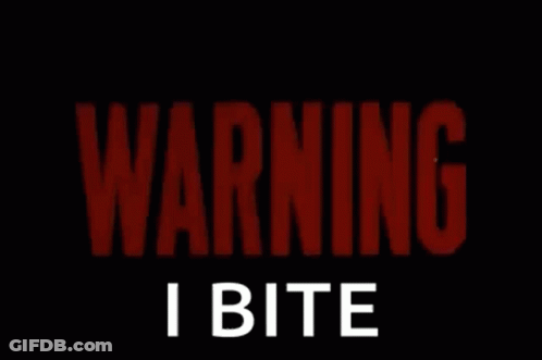 A Red Sign That Says Warning I Bite On It GIF