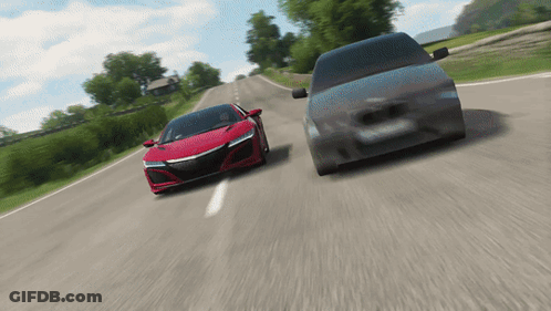 A Red Sports Car And A Black Van Are Driving Down A Road GIF