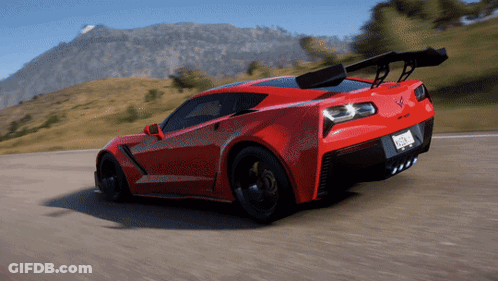 A Red Sports Car Is Driving Down A Road With Mountains In The Background And A License Plate That Says California GIF