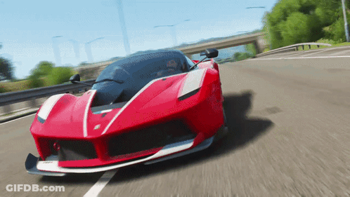 A Red Sports Car Is Driving Down The Road GIF