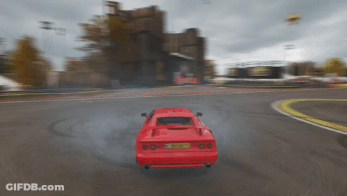 A Red Sports Car With A License Plate That Says ' A ' On It Is Driving Down A Road GIF