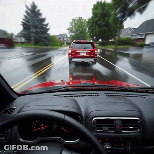 A Red Suv With A License Plate That Says ' A ' On It Is Driving Down A Wet Road GIF