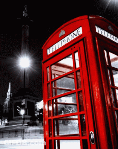 A Red Telephone Booth With The Word Telephone On The Front GIF