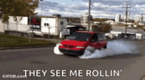 A Red Van Is Driving Down A Street With Smoke Coming Out Of The Tires And The Words They See Me Rollin GIF