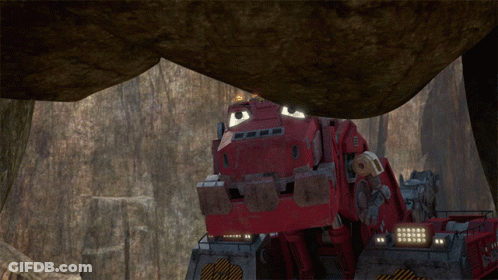 A Red Vehicle Is Driving Through A Rocky Area GIF