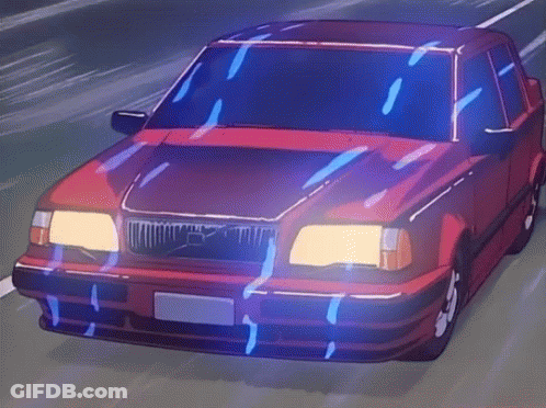 A Red Volvo Is Driving Down A Road At Night GIF