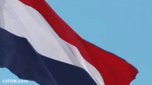 A Red White And Blue Flag Waving In The Wind GIF