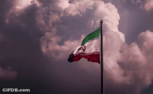 A Red White And Green Flag Is Flying In The Wind GIF