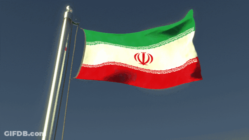 A Red White And Green Flag With A Red Circle In The Middle Is Flying In The Wind GIF
