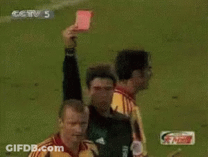 A Referee Holds Up A Red Card In Front Of A Player Wearing A Yellow Jersey With The Number 22 On It GIF