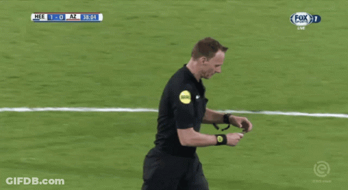 A Referee Holds Up A Yellow Card During A Soccer Match GIF