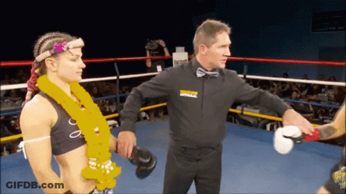 A Referee In A Boxing Ring With The Word Apparel On His Sweatshirt GIF